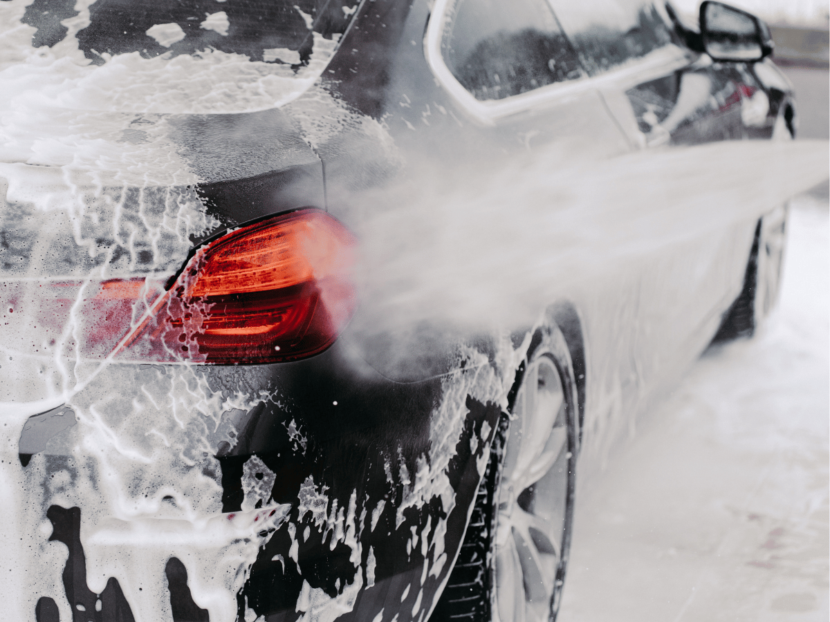 A thorough hand wash of the car's exterior to remove dirt, dust, and grime