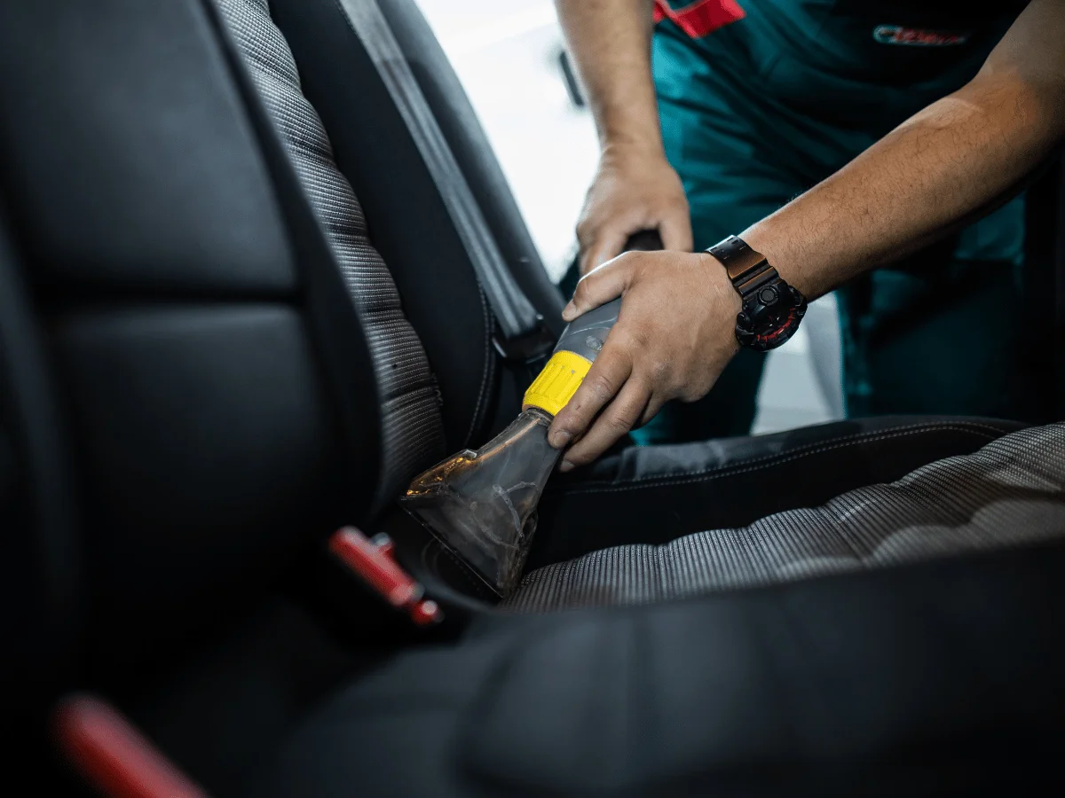 Vacuuming, wiping surfaces, and sanitising the car’s interior